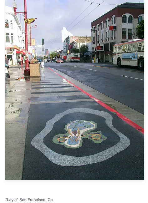 a picture of an artwork on the sidewalk, there is a white wavy circle around another image