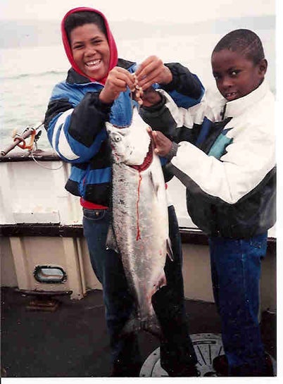 2 youths holding fish