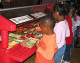 kids getting food at a salad bar